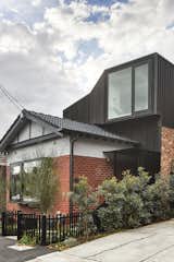 An end side entry canopy provides shelter and privacy, while the substantial extension watches over the street 