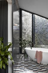Bathrooms pack a punch of colour and fun with highly patterned tiling. This ensuite is an oasis in the trees with filtered light through the perforated screen 