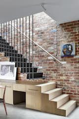 recycled brick and black steel to the interiors evoke a sense of the industrial heritage of the area, while joinery below maximises storage