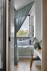 Soft curtains providing screening between bedroom study and sleeping zone. Shelves and desks are integrated through each room to enable going family needs and work form home places for all 