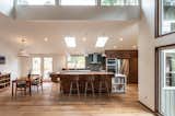 Removing the wall lets light from the clerestory windows reach the north facing kitchen and dining room. Two new skylights over the work island were also added.