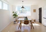 The open plan living level was located on the top floor to maximize light and views. Furnishings and artwork by Birdloft, RePly Furniture, Studio Make, and Minka Tacoma.