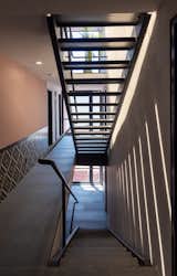 Staircase, Metal Railing, and Metal Tread niu Coliving Stairs  Photo 5 of 16 in Niu Coliving by CRAFT Arquitectos