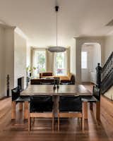 Living Room, Sectional, Pendant Lighting, Dark Hardwood Floor, and Wood Burning Fireplace Parlor floor living area  Photo 11 of 32 in Luminaires by Julie from Pocket Doors Create Privacy in a Couple’s Renovated Brooklyn Brownstone