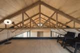 an outstanding pitched roof is supported by a wooden structure.