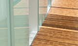 detail of the end grain hardwood floors to the walls clad in translucent glass.