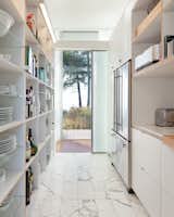 View into the open pantry that hides away the clutter from the open kitchen. 