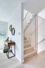 Central staircase with hand-crafted 13-foot oak balastrades that match the white oak hardwood flooring throughout these homes.