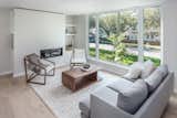 Living space with oversized south-facing windows that provide an unobstructed view of their quite tree-lined street. 