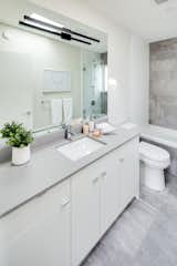 Concrete tile flooring and polished concrete counters in the common bath on the top floor