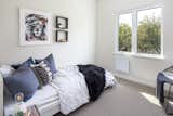 Light gravel coloured wool carpet create cozy bedroom spaces with simply white walls.