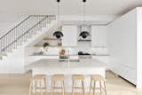 Kitchen | White island and cabinetry with brushed white oak hardwood floors.