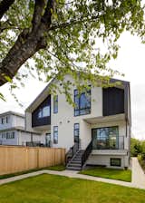 Rear exterior | Vertical burnt wood siding mixed with stucco.  Black window frames and metal railings.