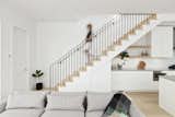 Interior staircase with black metal railings and white oak steps