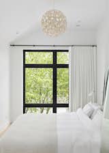 Principle bedroom | White selections, natural wood pendant light and black window frame