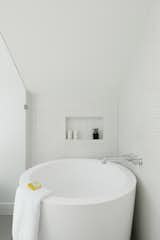 Principle Bathroom | Round Soaker Tub with inset shelf in tile wall.