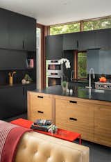The black Richlite and walnut kitchen is one of Mongillo's favorite elements of the home. He says that kitchens often feel out of place—but this one is an architectural feature, with the island acting as another piece of furniture.