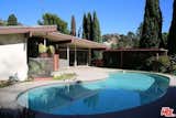 The home resides on a 10,000-square-foot lot and therefore provides ample room to entertain guests outside and enjoy the temperate L.A .weather. The pool was in decent shape but, like the rest of the house, needed a bit of a facelift.   Photo 14 of 17 in Before & After: An Enterprising Couple Revive a Dated Midcentury in the Hollywood Hills