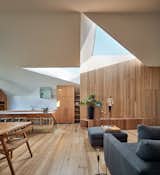 His and Hers House by FMD Architects living room with triangular skylights