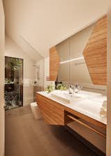 The bathroom has shapes meant to represent Pam and Arthur, and brings in the same tile used in the kitchen. The countertop is Corian, and the cabinet fronts are plywood.&nbsp;