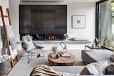 The living room offers a touch of Nordic simplicity with a combined steel TV unit and fireplace from Space Furniture, rattan chair from IKEA, C-shape gunmetal table from Casalife, and art from Cocoon Furnishings.&nbsp;