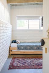 In the kid-friendly bunk room, Lewis went with Natalie Meyers Veneer Design daybeds, a light from Frances and Son, accessories from The Garage Collective (Lewis's own store), and stump side table she made herself. 