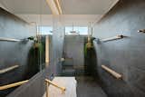 Custom brass plant shelves and custom tile adorns the master bathroom.