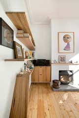 Recycled timber shelves stretch from the front hallway into the living areas, linking the old and the new.