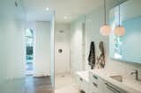 Toyath Residence by Webber + Studio all-white bathroom with glass-enclosed, walk-in shower