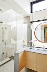 Another ask? The couple wanted separate showers. While the architects thought it would  be difficult to pull off, they were able to thanks to a floating wall "which gives a sense of privacy and skylight,