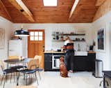 The new kitchen is a compact eight feet wide—and much more efficient. The Ikea cabinets have been modified and upgraded with hardware, attachments, and fixtures. A Smeg refrigerator replaces a corner cabinet and complements a European-scale cooktop and small oven.
