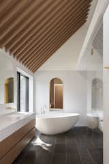 Wooden beams show off the 18.5-tall ceiling in the master bathroom.