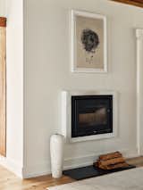 A vast departure from the original wood-burning fireplace, this modern fireplace allows for other elements in the room to share the attention.