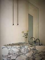 <span style="font-family: Theinhardt, -apple-system, BlinkMacSystemFont, &quot;Segoe UI&quot;, Roboto, Oxygen-Sans, Ubuntu, Cantarell, &quot;Helvetica Neue&quot;, sans-serif;">The powder bathroom became a full bathroom with the addition of a new vanity and plastered shower. "It is a unique challenge to work in a curved room with materials that don’t bend,