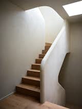  From closed off to comfortable, the stairwell is now a special moment in the home. "It's easy to forget but you do spend a lot of time going up and down [stairs] and it should be a pleasant experience," says the architect. 
