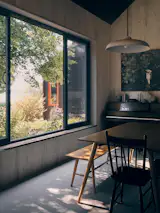 The interiors are honest and simple with pine walls sourced from Eastern Canada. <span style="font-family: Theinhardt, -apple-system, BlinkMacSystemFont, "Segoe UI", Roboto, Oxygen-Sans, Ubuntu, Cantarell, "Helvetica Neue", sans-serif;">"We didn't want to have any moldings. The [wood] starts from the concrete floor and around the windows there are more planks,