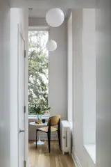 The rear extension is transformed into a quiet nook suitable for a morning coffee break.  Large windows bring the outdoors in and completely flood the space with light.  Photo by Kate Glicksberg.