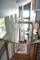 Staircase, Wood Tread, and Metal Railing Natural light spills in.  Photo 1 of 12 in Sharp Home by Amber Allen