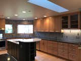 Lots of light from skylight above. Dishes and linens are stored on the same the wall as the dishwasher for easy access. The drawers on the far right are for files.  That section of the counter is used as a standing desk.