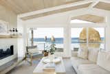 Melanie Gaither Interiors selected light, beachy furnishings and finishes to match the view outside Haystack Rock Getaway. A deck outside the living room extends the connection to the ocean.