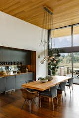 Dining Room, Chair, Storage, Shelves, Bar, Pendant Lighting, and Medium Hardwood Floor  Photo 8 of 17 in Cedar Island Residence by Scott Edwards Architecture