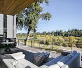 Outdoor, Shrubs, Metal Fences, Wall, Back Yard, Trees, and Large Patio, Porch, Deck  Photo 11 of 17 in Cedar Island Residence by Scott Edwards Architecture