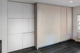225 square feet is maximized with a clever, custom storage wall that hides a series of retractable necessities: