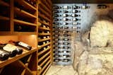Rock penetrates the building envelope in the wine cave, providing a naturally cool temperature. Pegs inserted in the foundation add storage capacity.