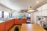 The orange custom cabinets in the kitchen were specially manufactured by Factory Tool.&nbsp;