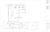 The floor plan shows the layout of the house with two wings and a garage converted into a performance space.