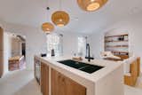 Kitchen, Concrete Floor, Pendant Lighting, Undermount Sink, Cooktops, and Ceiling Lighting Bierman designed the custom wood and resin kitchen cabinetry with a carpenter.  Photos from An Architect’s Weekend Home Along the French Riviera Borrows Stones From Ancient Ruins
