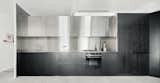 The architect designed the kitchen cabinets with black-wood cabinetry and stainless steel.&nbsp;