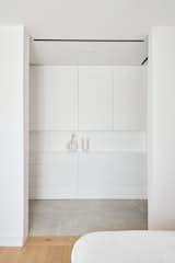 The en suite bathroom features a walk-in closet with custom shelving.