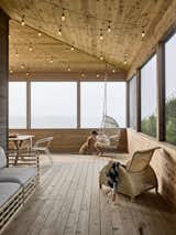 Wide porch screens and warm wood tones give the outdoor space a casual livability.